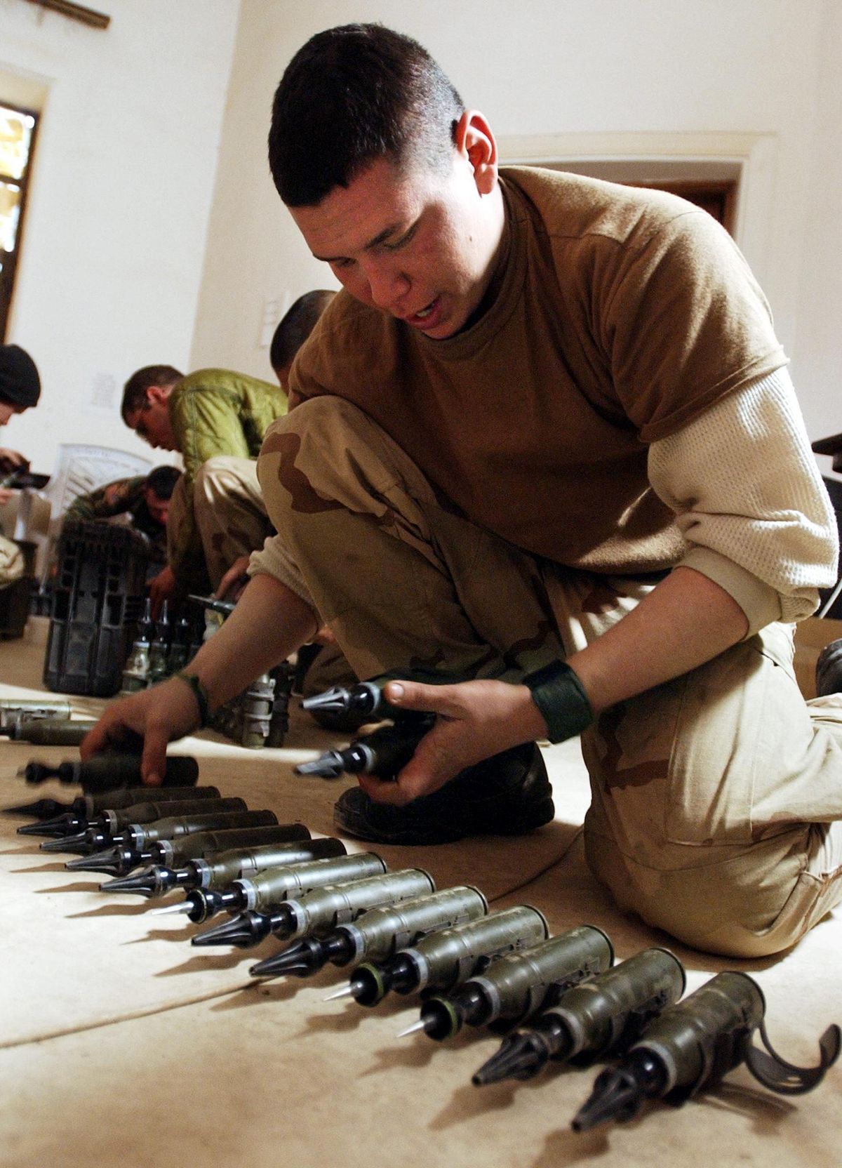 Amerikai katona szemlézi a szegényített uránt tartalmazó páncéltörő lövedékeket 2004. február 11-én az iraki Tikritben   (forrás: STAN HONDA / AFP)