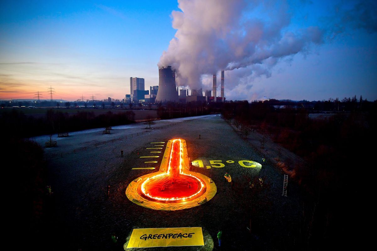 A Greenpeace környezetvédő szervezet aktivistái hőmérőt megjelentítő, lángoló installációval tüntetnek a Niederaussem barnaszén-tüzelésű hőerőműnél az észak-rajna-vesztfáliai Bergheimnél 2019. január 22-én. MTI/EPA/Sascha Steinbach