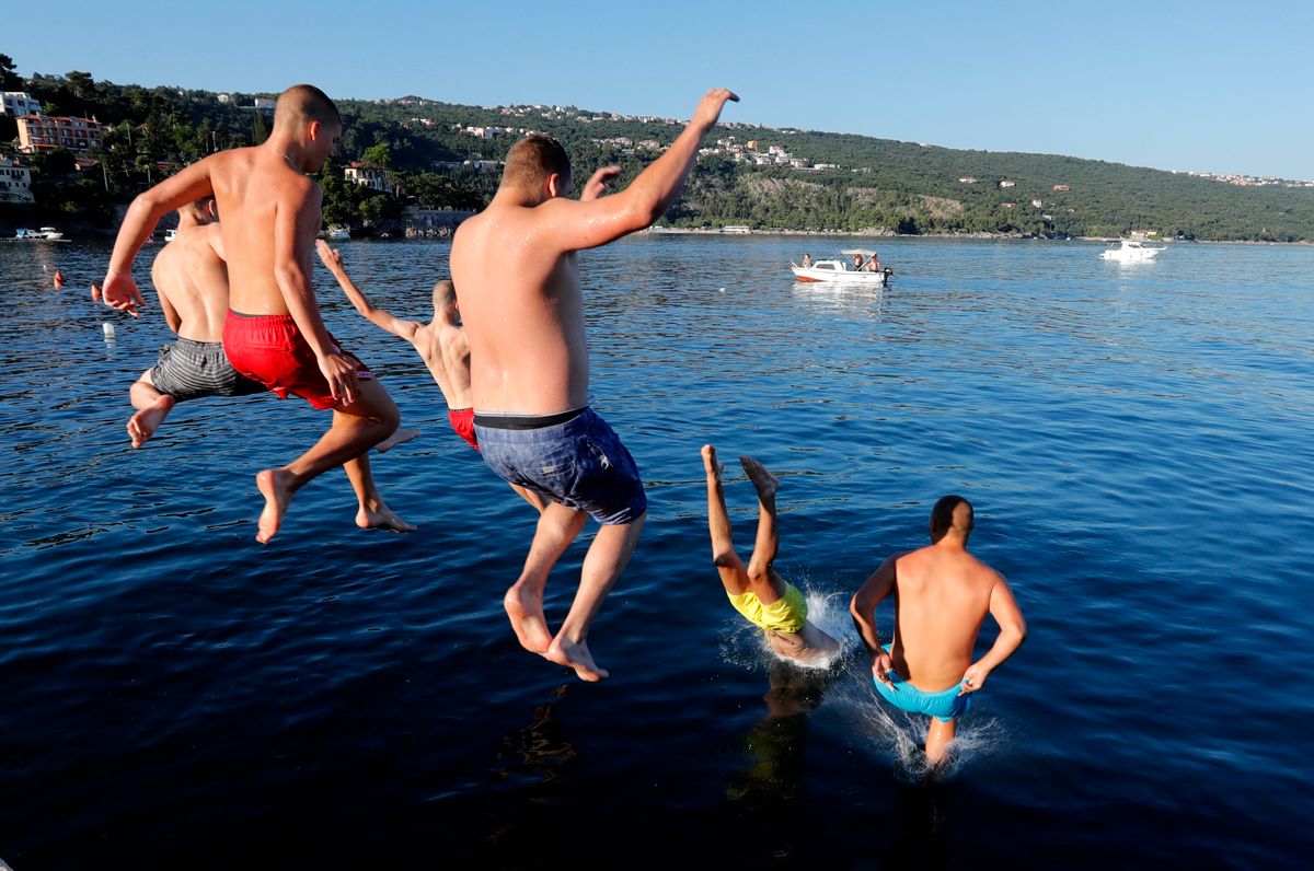 Vízbe ugró turisták a horvátországi Abbáziában (Opatija) 2020. június 30-án. (MTI/EPA/Antonio Bat)