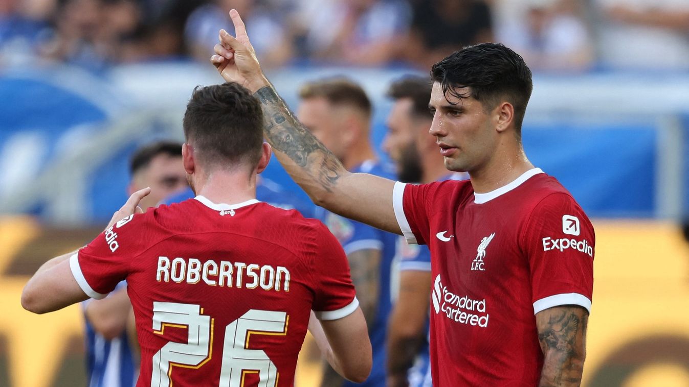 Liverpool's Hungarian midfielder Dominik Szoboszlai (R) speaks with Liverpool's Scottish defender Andrew Robertson during the pre-season friendly football match between Karlsruhe SC and Liverpool FC in Karlsruhe, western Germany, on July 19, 2023. (Photo by Daniel ROLAND / AFP)