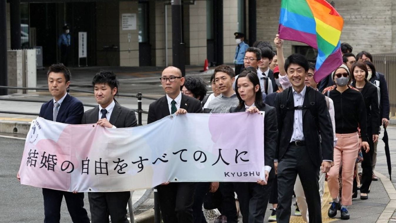 Plaintiffs head to the court with a banner for same-gender marriage lawsuit at the Fukuoka District Court in Fukuoka City, Fukuoka Prefecture on June 8, 2023.