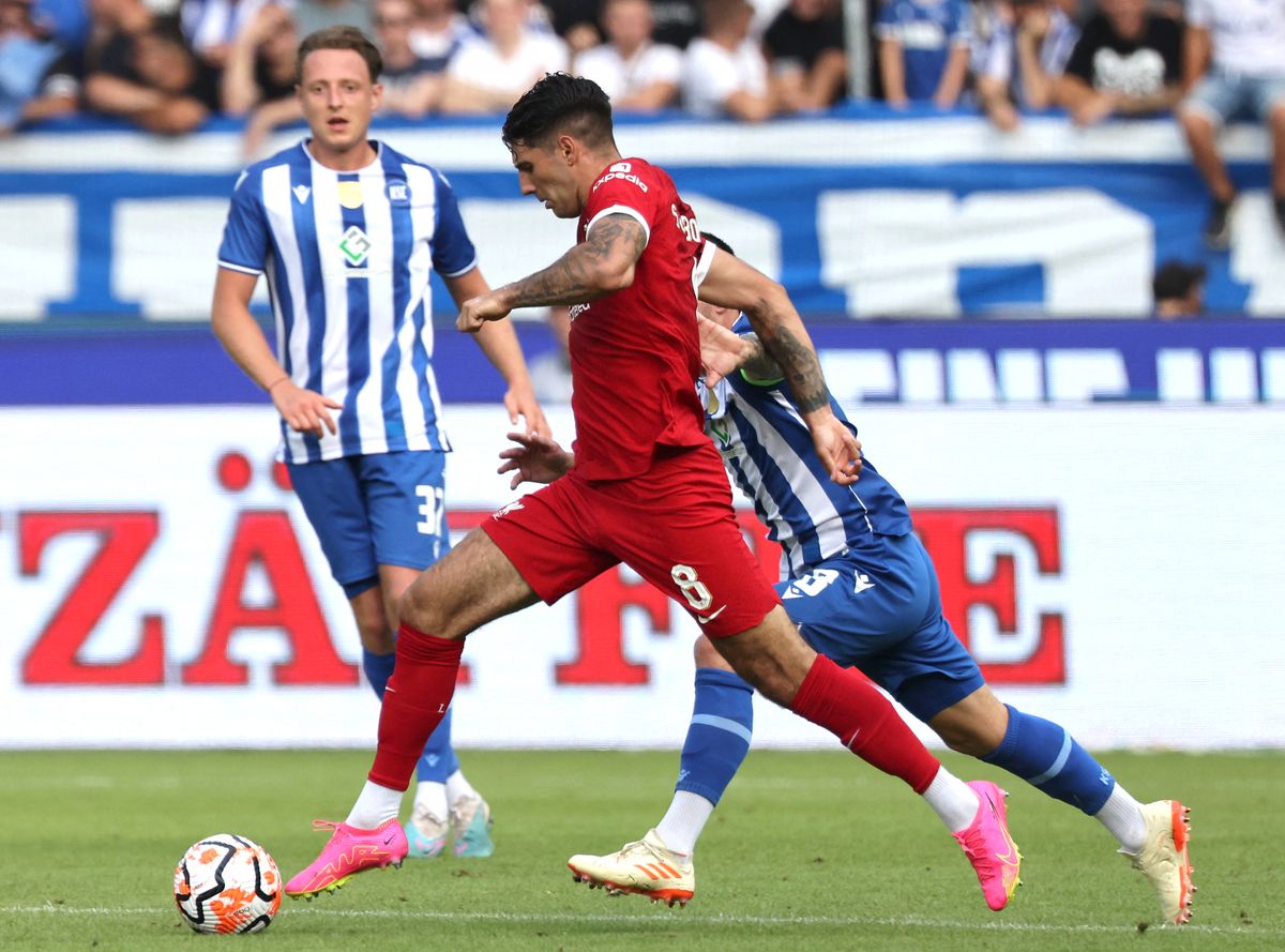 Liverpool's Hungarian midfielder Dominik Szoboszlai and Karlsruhe’s Jerome Gondorf vie for the ball during the pre-season friendly football match between Karlsruhe SC and Liverpool FC in Karlsruhe, western Germany, on July 19, 2023. (Photo by Daniel ROLAND / AFP)