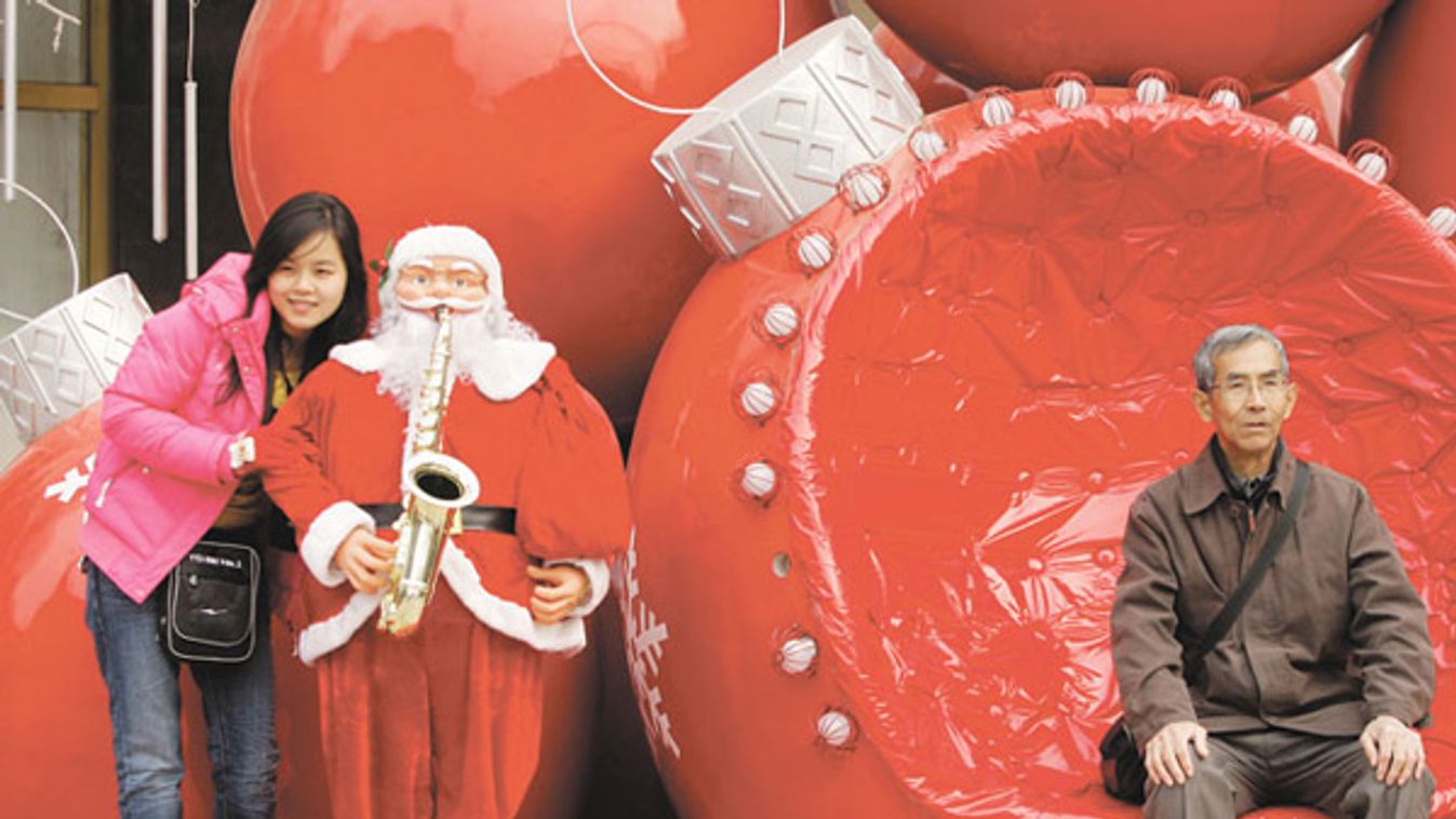 People pose for photos with Christmas decorations in Beijing