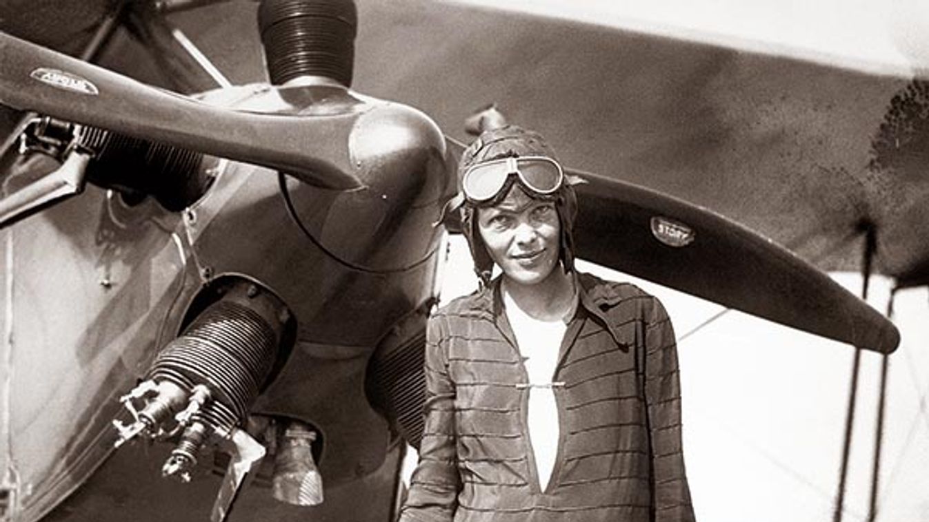 Amelia Earhart Stands In Front of Plane