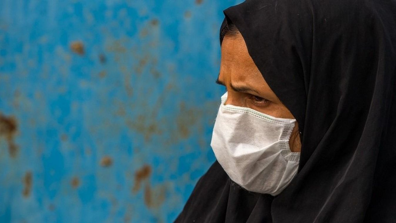 IRAN - A WOMAN WEARING A FACE MASK TO PROTECT FROM H1N1 INFLUENZA IN PANJSHAMBE BAZAR - MINAB