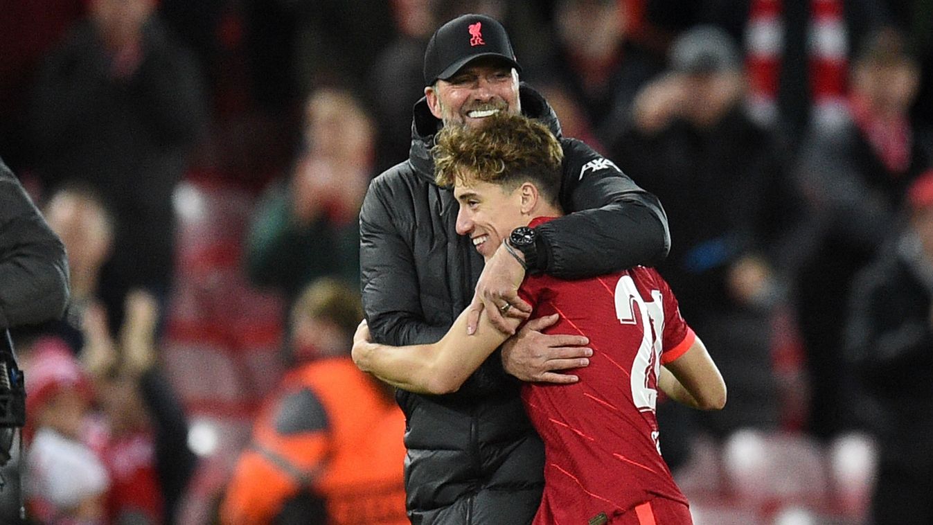 Liverpool's German manager Jurgen Klopp hugs Liverpool's Greek defender Kostas Tsimikas after the UEFA Champions League group B football match between Liverpool and Atletico Madrid at Anfield in Liverpool, north west England on November 3, 2021. (Photo by Oli SCARFF / AFP)