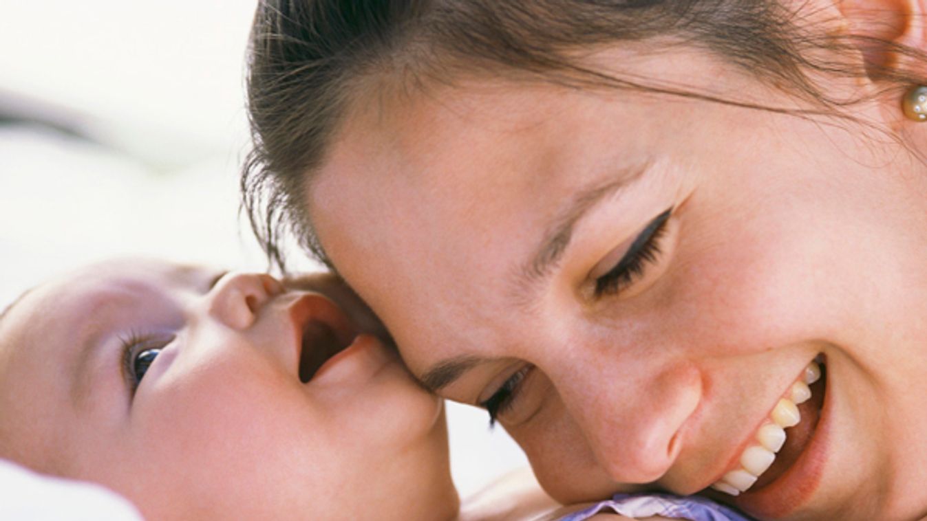 Mother Resting Head on Infant's Chest