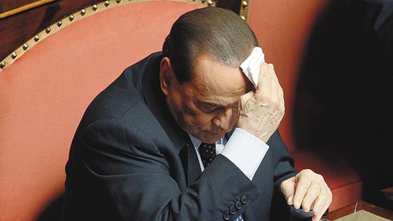 People of Freedom (PDL) party member and former Prime Minister Silvio Berlusconi wipes his forehead as he attends the Upper house of the parliament in Rome