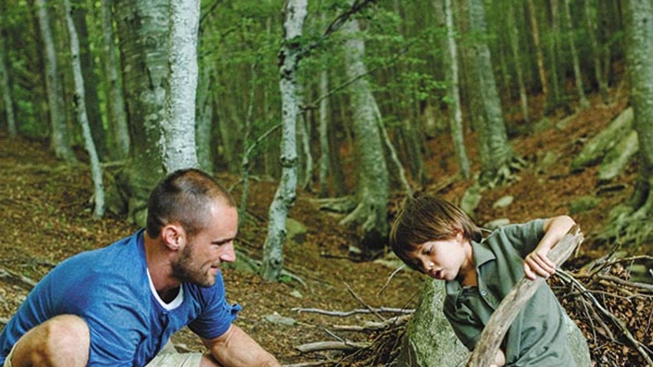 Father and son playing in woods