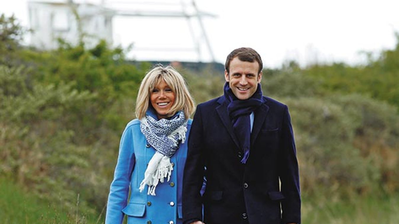 Emmanuel Macron, head of the political movement En Marche! (Onwards!) and candidate for the 2017 presidential election, and his wife Brigitte Trogneux pose for a photograph in Le Touquet
