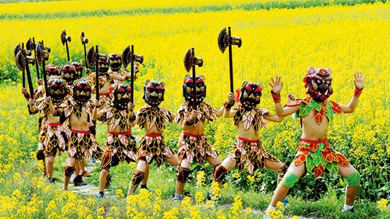 Nuo dance performed in east Chinas cole flower fields