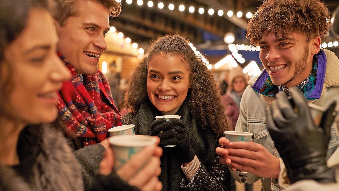 Group,Of,Friends,Drinking,Mulled,Wine,At,Christmas,Market