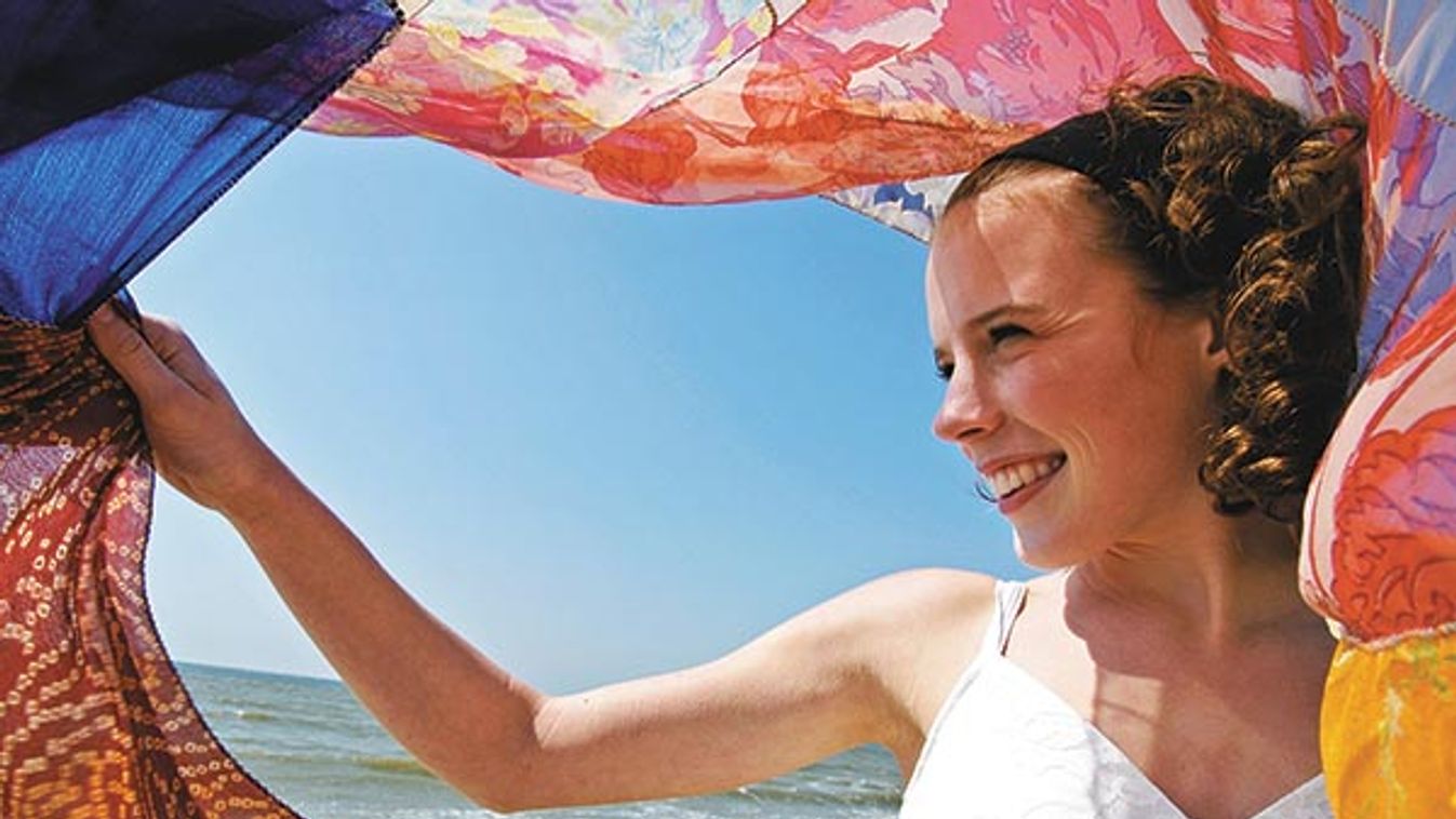 Teenage girl young woman on the windy beach of Vlissingen Zeeland the Netherlands