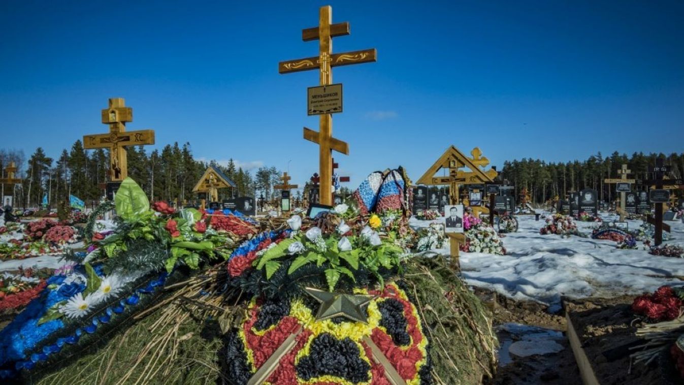 Grave in the Beloostrovsky cemetery of Dmitry Menshikov, a criminal inmate recruited in a Russian jail by the Wagner group as a mercenary in the Russian invasion war in Ukraine, is being adorned with flowered crowns with two swords and red and yellow flowers, which is used by the Wagner group for its killed members during the war in Ukraine.