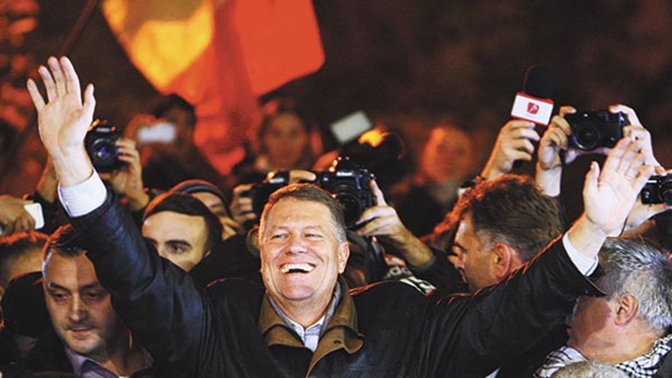 Romanian presidential candidate Klaus Iohannis celebrates his victory in the election run-off, with protesters in central Bucharest