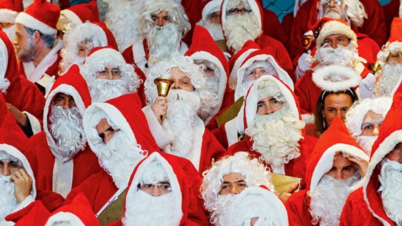 People dressed in Santa Claus costumes pose for group picture during annual meeting of participants of university rent-a-Santa Claus service in Berlin