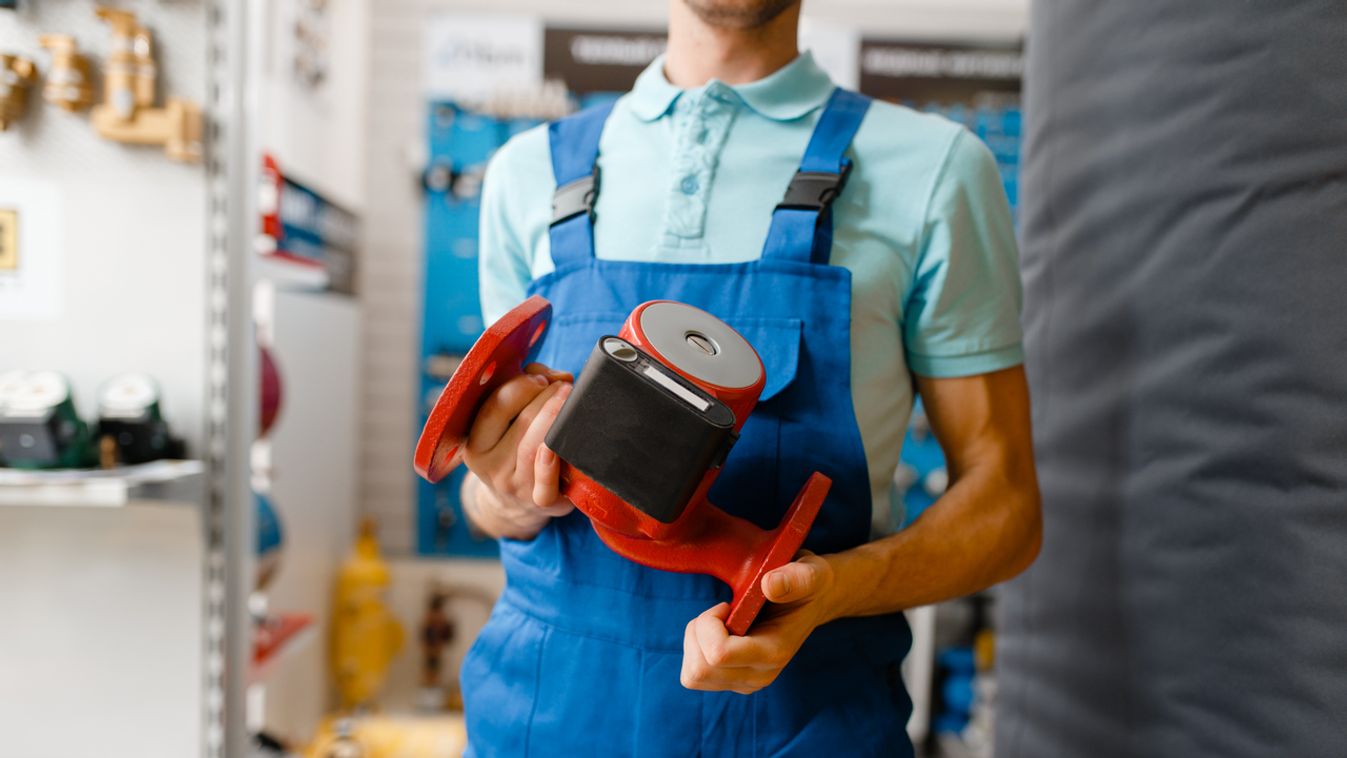 Plumber holds water pump, plumbering store