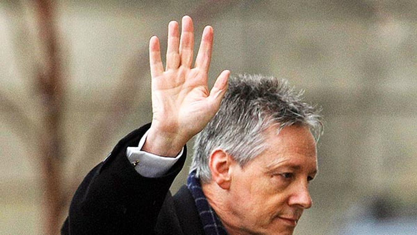 Northern Ireland's First Minister Peter Robinson gestures as he arrives at Stormont in Belfast