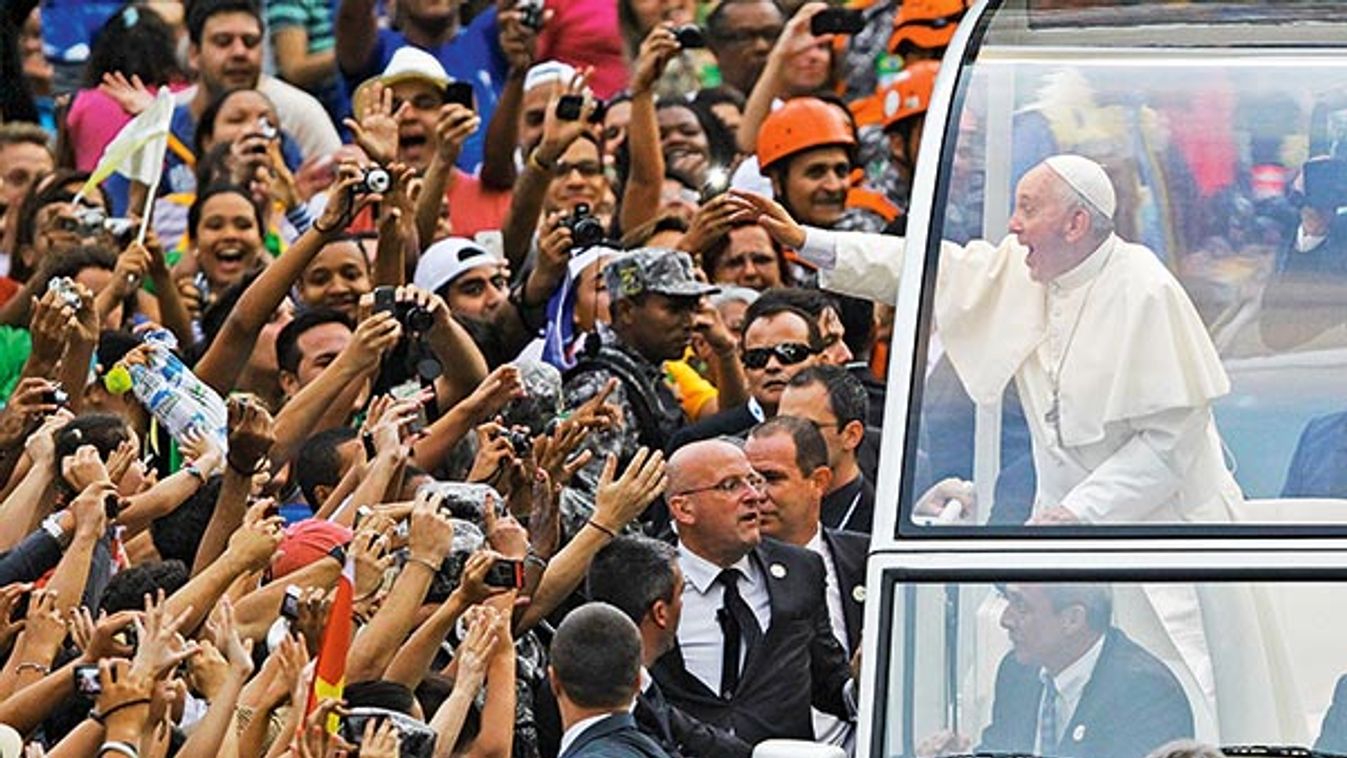 Pope Francis greets crowd of faithful from popemobile in downtown Rio de Janeiro