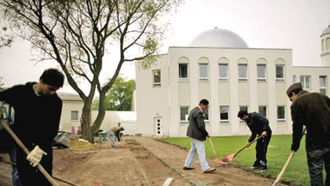 Workers construct a path in front of the newly built Ahmadiya mosque in the Heinersdorf district of Berlin