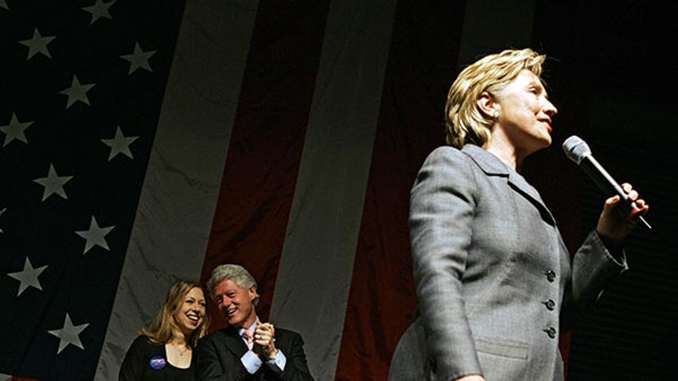 Former US President Clinton and his daughter Chelsea listen as his wife U.S. presidential candidate Sen. Rodham Clinton (D-NY) speaks at a fundraising rally in New York