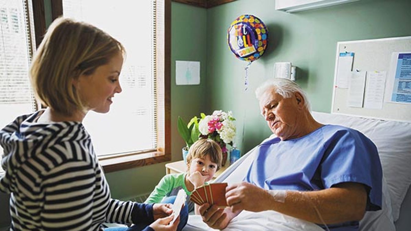 Multi-generation family playing cards in hospital