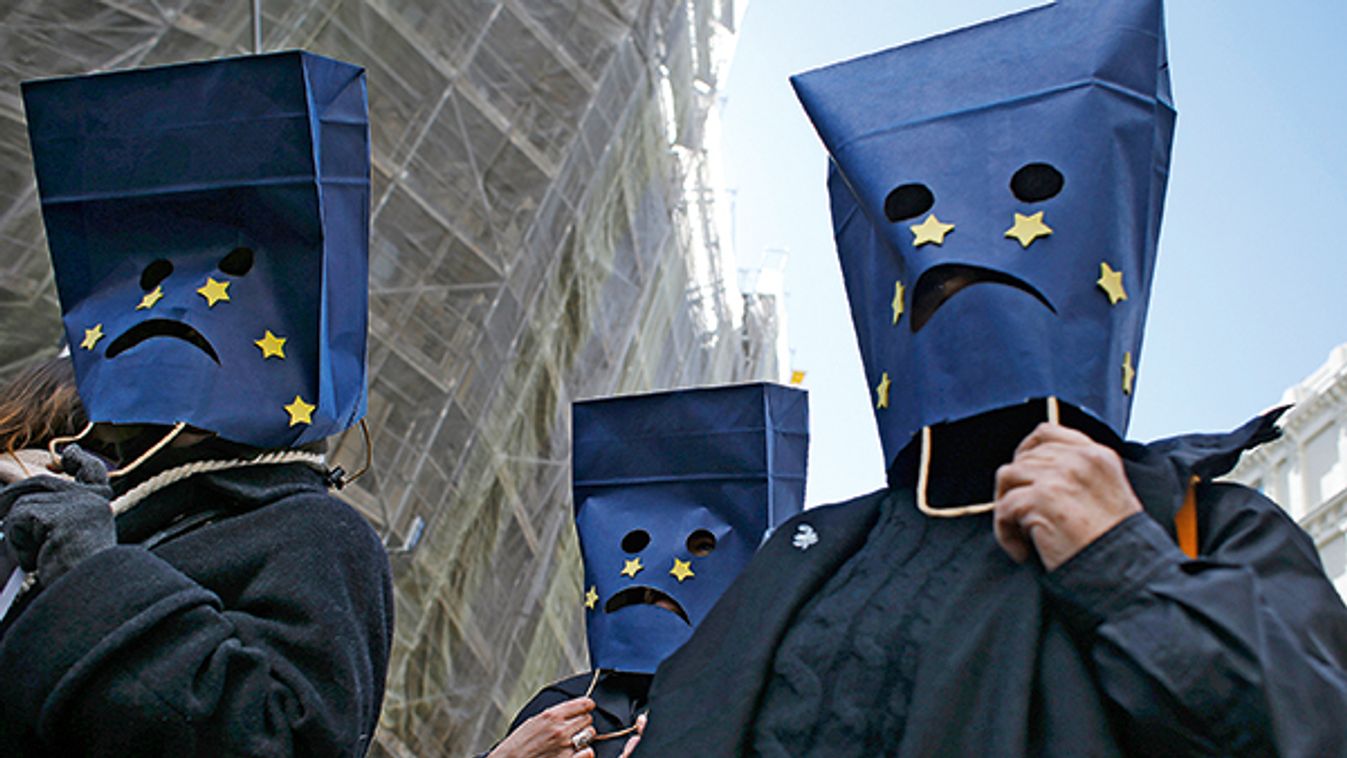 Demonstrators wearing bags on their heads attend a news conference outside Spain's Parliament in Madrid