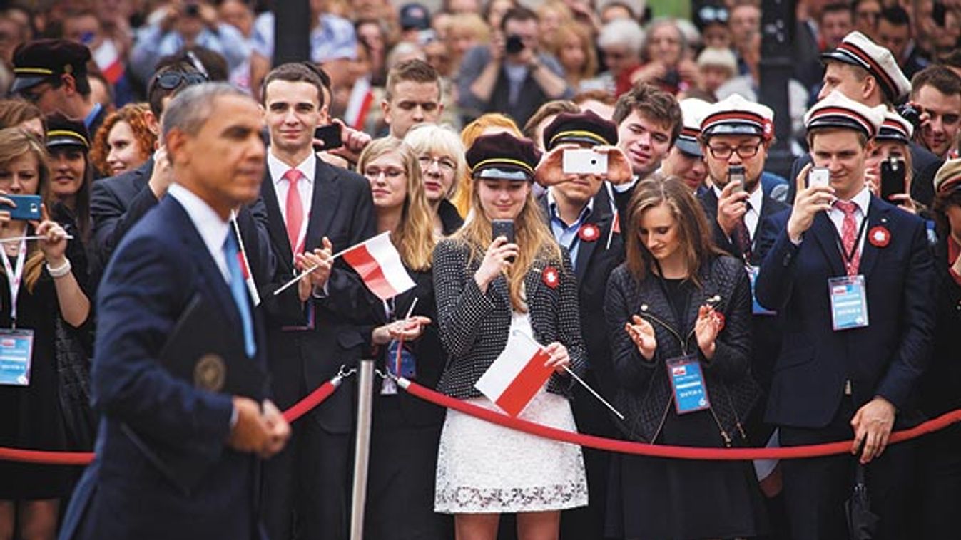 Members of the audience take photos as President Barack Obama passes during a ceremony commemorating the 25th anniversary of the first partially free