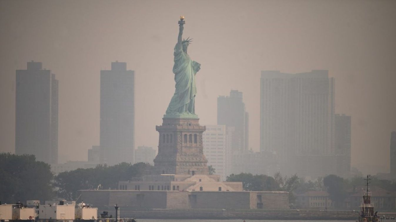 The Statue of Liberty from the Staten Island Ferry during heavy smog in New York on June 6, 2023. Smoke from Canada’s wildfires has engulfed the Northeast and Mid-Atlantic regions of the US, raising concerns over the harms of persistent poor air quality.
