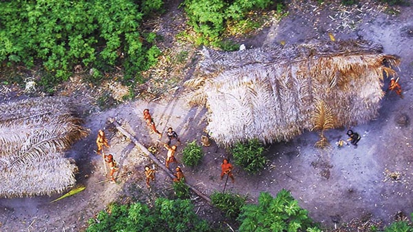 Handout photo shows members of an unknown Amazon Basin tribe and their dwellings during a flight over the Brazilian state of Acre along the border with Peru