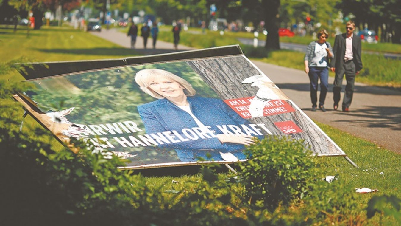 An election poster of North Rhine-Westphalia State Premier and Social Democrats (SPD) candidate Hannelore Kraft is seen on the street in Leverkusen