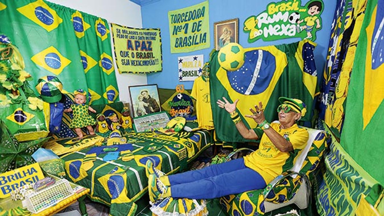 Brazilian soccer fan Guimaraes da Silva plays with a ball as she poses for picture, at her home in Brasilia