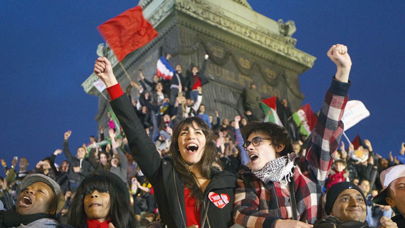 Supporters of France's newly-elected President Francois Hollande react after the early results during a victory rally at Place de la Bastille in Paris