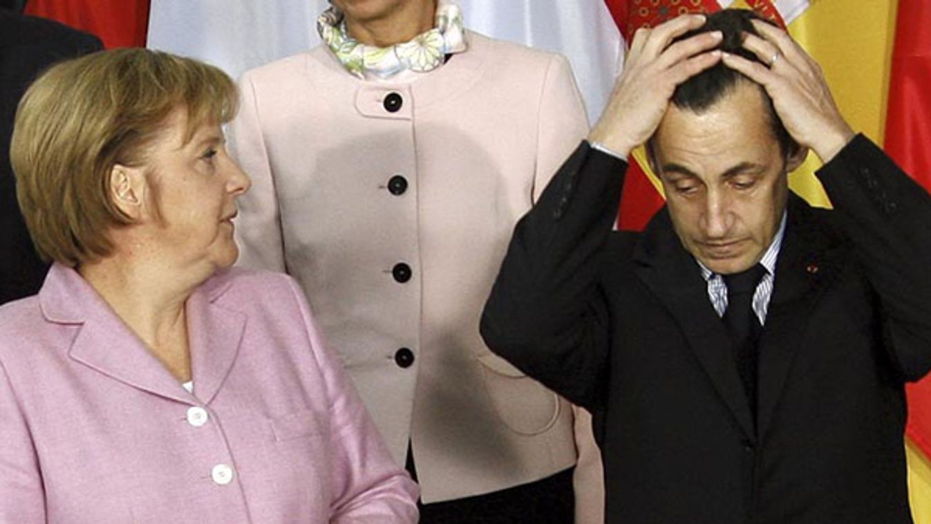 German Chancellor Merkel looks at French President Sarkozy as they pose for a picture after a meeting in the Chancellery in Berlin