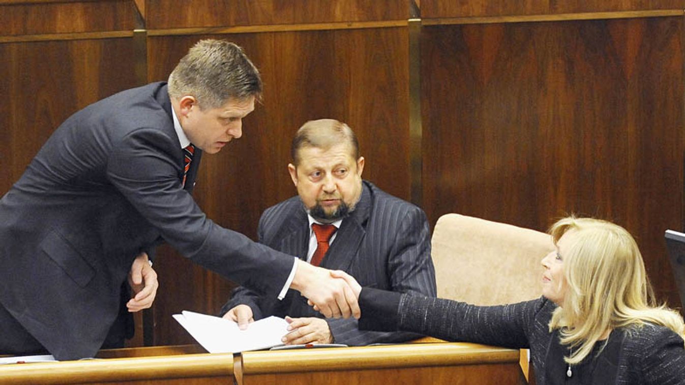 Slovakia's incoming PM Fico shakes hands with former PM Radicova during the initial session of the new National Council of the Slovak Republic in Bratislava