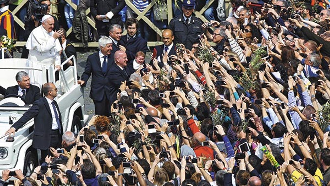 Pope Francis waves to the faithful during the Palm Sunday mass at Saint Peter's Square at the Vatican