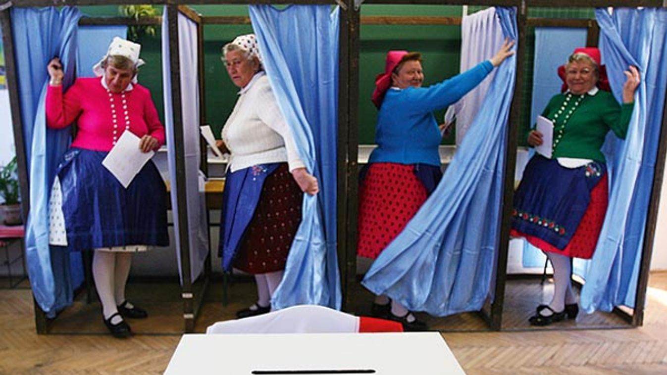 Elderly Hungarian women dressed in traditional clothes vote in Hungary's general election in Veresegyhaza