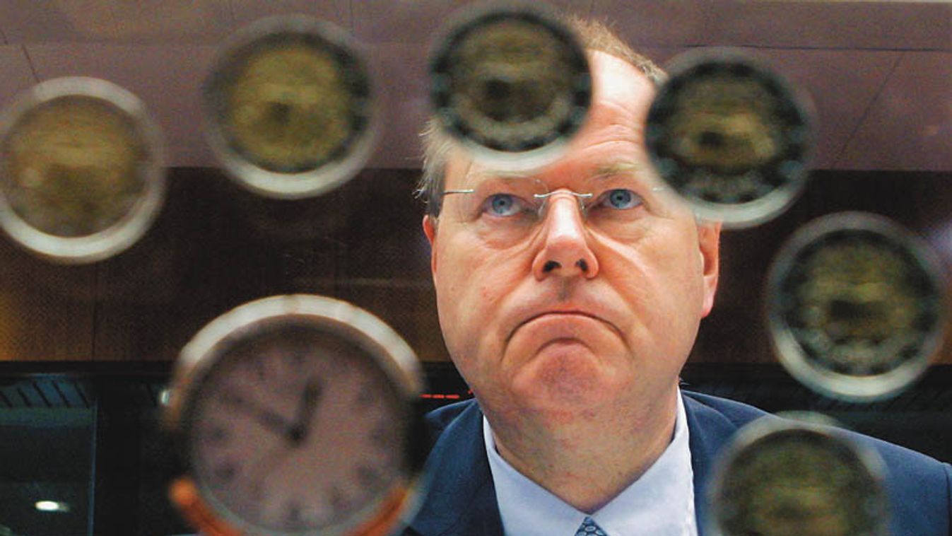 Germany's Finance Minister Peer Steinbrueck looks through a clock made with euro coins at the start of a European Union finance ministers meeting in Brussels