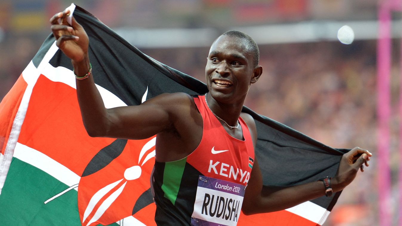 Kenya's David Lekuta Rudisha celebrates with his country's flag after winning the race and breaking the world record in the men's 800m final at the athletics event during the London 2012 Olympic Games on August 9, 2012 in London. With his world record-breaking Olympic 800m triumph, David Rudisha achieved a long-held goal of going one better than the silver medal his father, Daniel, won at the 1968 Games. AFP PHOTO / ERIC FEFERBERG (Photo by Eric Feferberg / AFP)