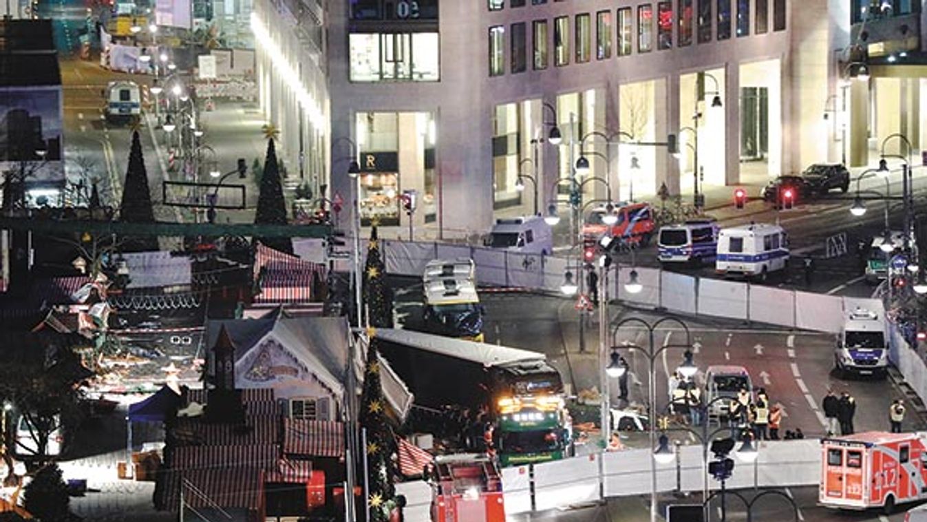 A tow truck operates at the scene where a truck ploughed through a crowd at a Berlin Christmas market