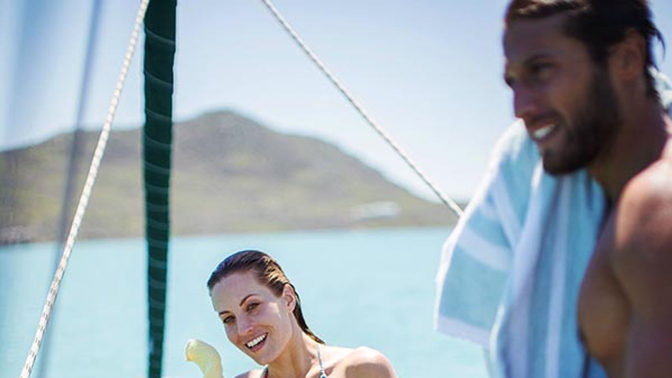 Couple toweling off on boat in water