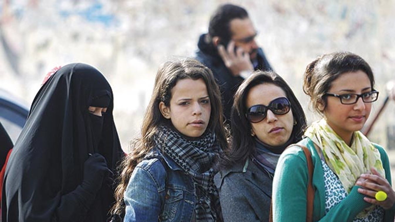 Women queue outside a polling centre in Cairo