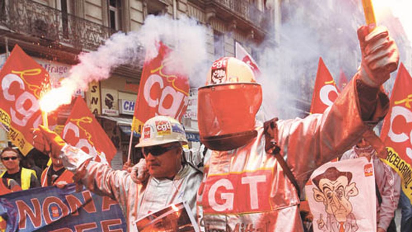 Arcelor Mittal steel workers dressed in protective work suits demonstrate over pension reforms in Marseille