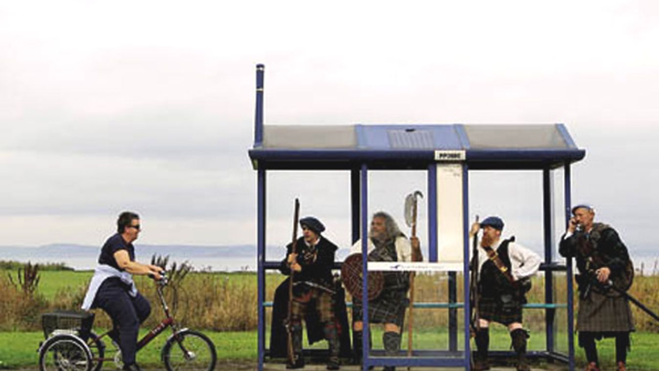 Jacobite Highlander re-enactors sit in a bus stop, during a media event for the forthcoming Battle of Prestonpans re-enactment in Scotland