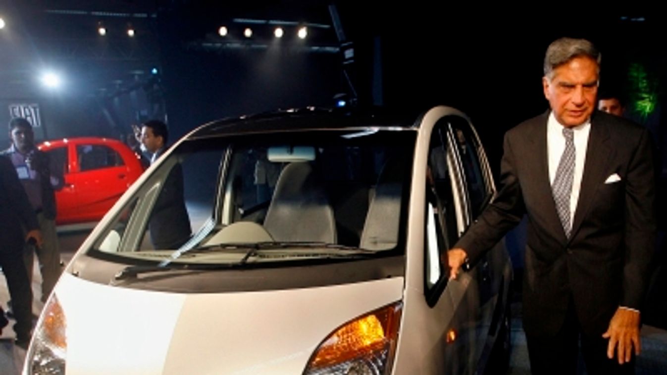 India's Tata Group Chairman Tata poses with the company's new "Nano" car during its launch in New Delhi