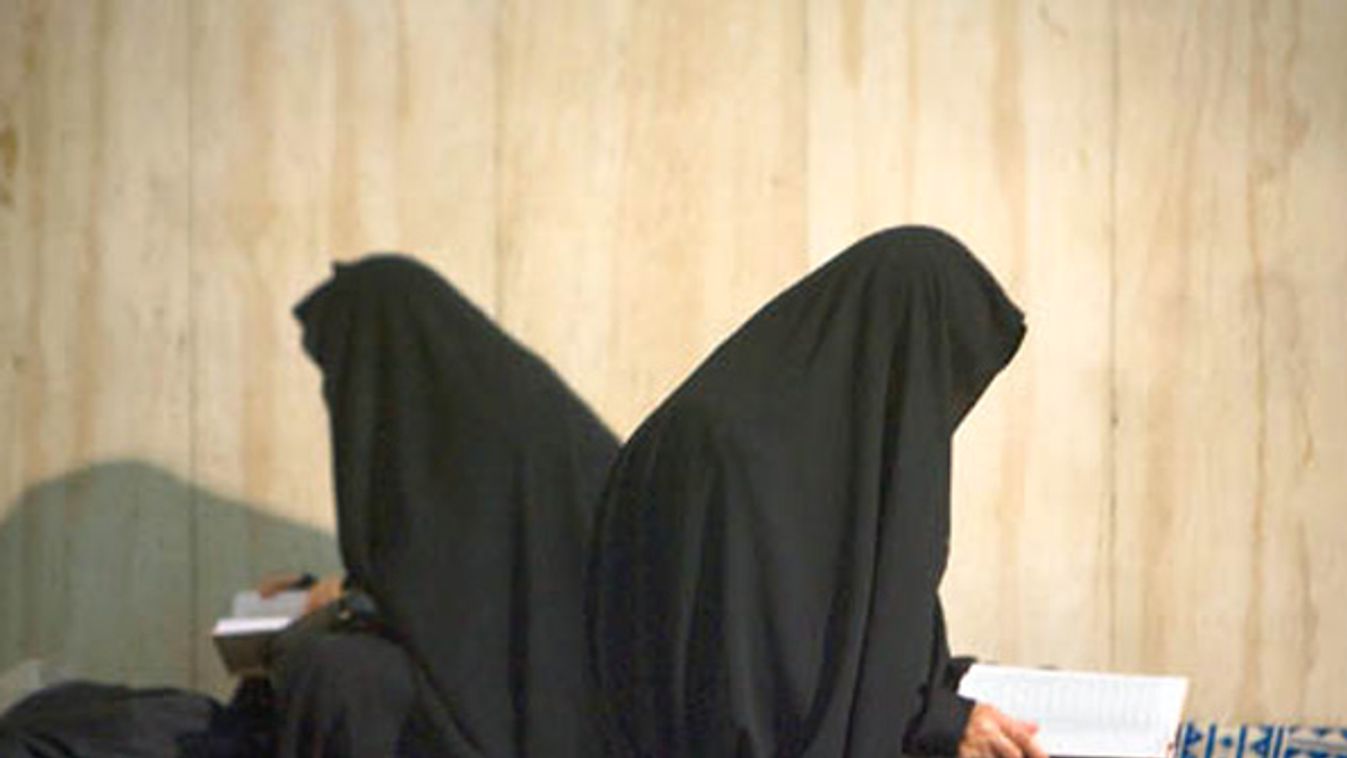 Two women pray during a ceremony to mark the Islamic Republic founder Ayatollah Ruhollah Khomeini's death anniversary at a mosque in northern Tehran