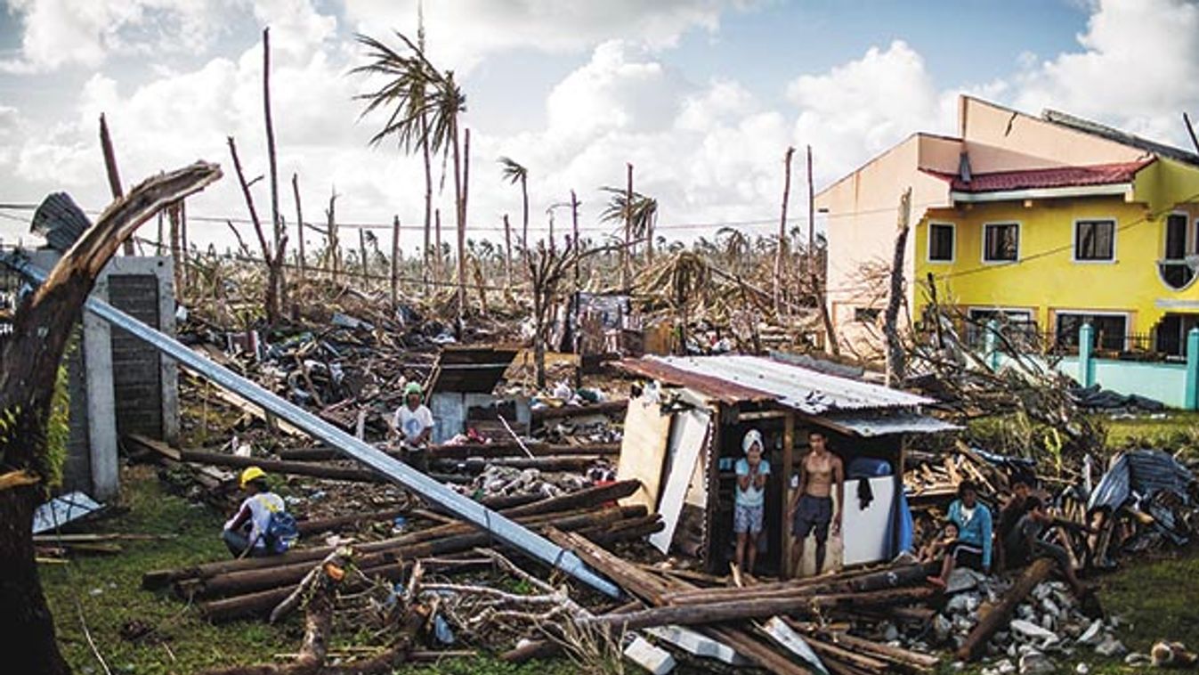 A man and woman stand outside a makeshift shelter in Guiuan, on the eastern end of Samar Island, Philippines.