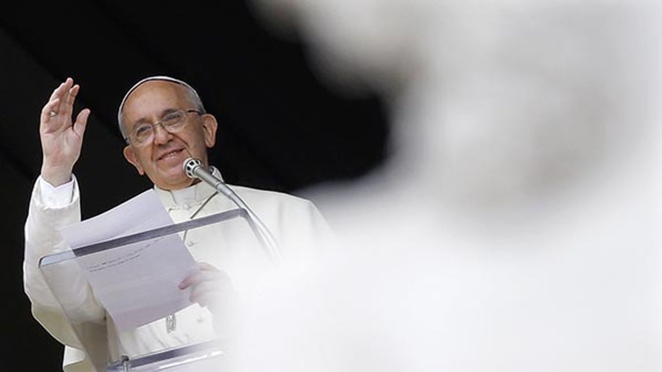 Pope Francis waves as he leads the Angelus prayer from the window of the Apostolic palace in Saint Peter's Square at the Vatican