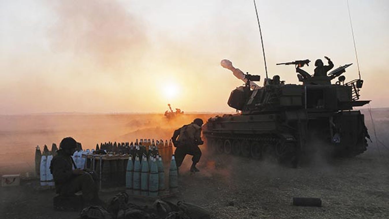 An Israeli mobile artillery unit fires towards the Gaza Strip