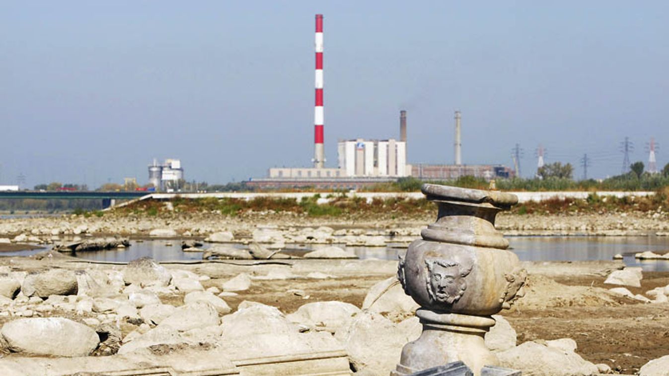 The artefacts in the Vistula riverbed revealed by low water levels are pictured with a power plant in the background in Warsaw